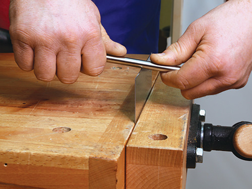 Applying pressure to burnishing tool during sharpening