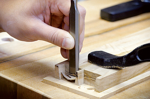 Huy Huynh cutting joinery with a chisel